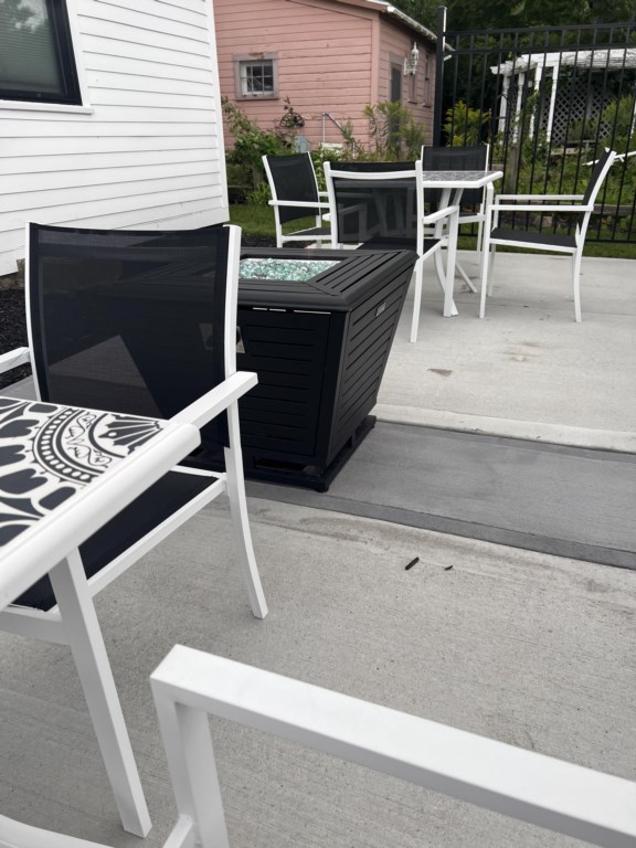Victorian outdoor common area space with grill and fire pit