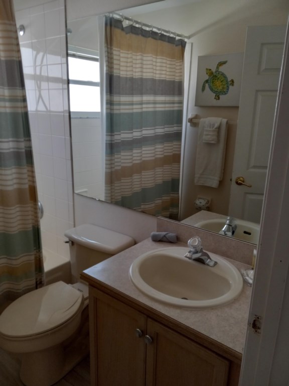 Bathroom with bathtub and shower over