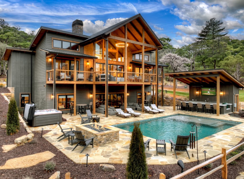 Luxurious home with a private pool and expansive outdoor lounging areas.