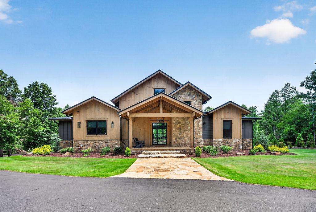 Charming rustic exterior with spacious front yard and inviting porch.