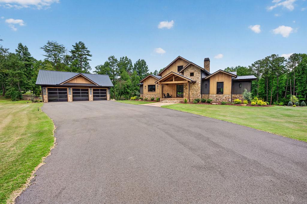 Charming countryside home with spacious driveway and scenic wooded surroundings.
