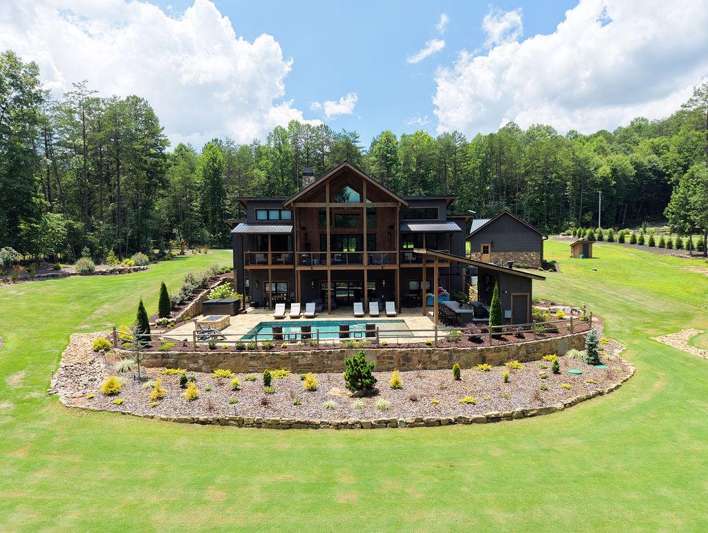 Expansive lodge with private pool and lush forest views, perfect for a serene getaway.