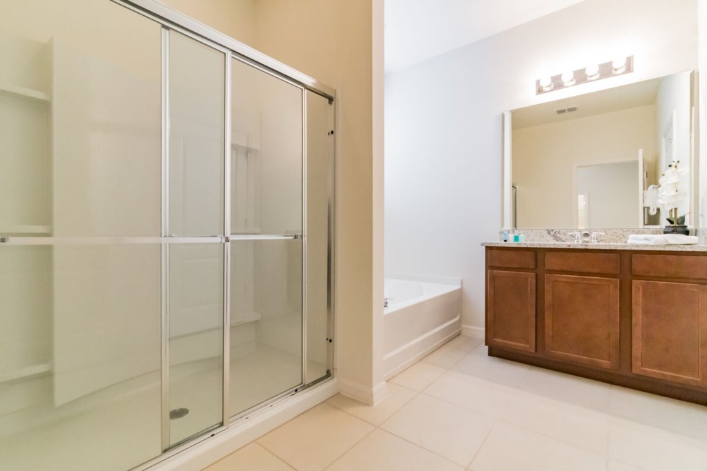 bathroom with shower and a bathtub