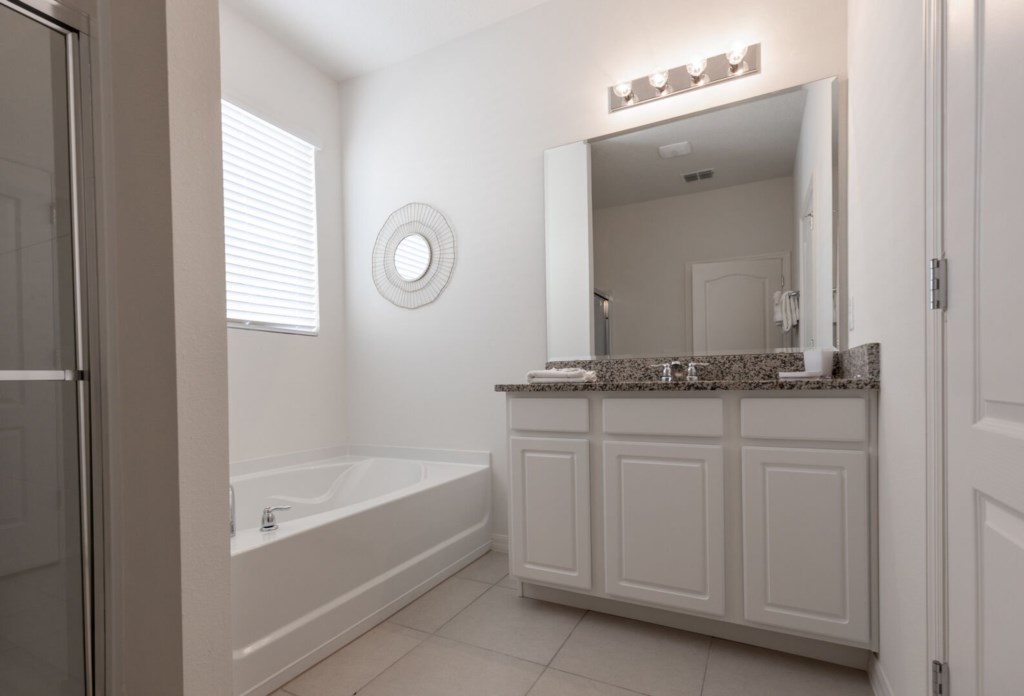bathroom with shower, bathtub & huge mirror