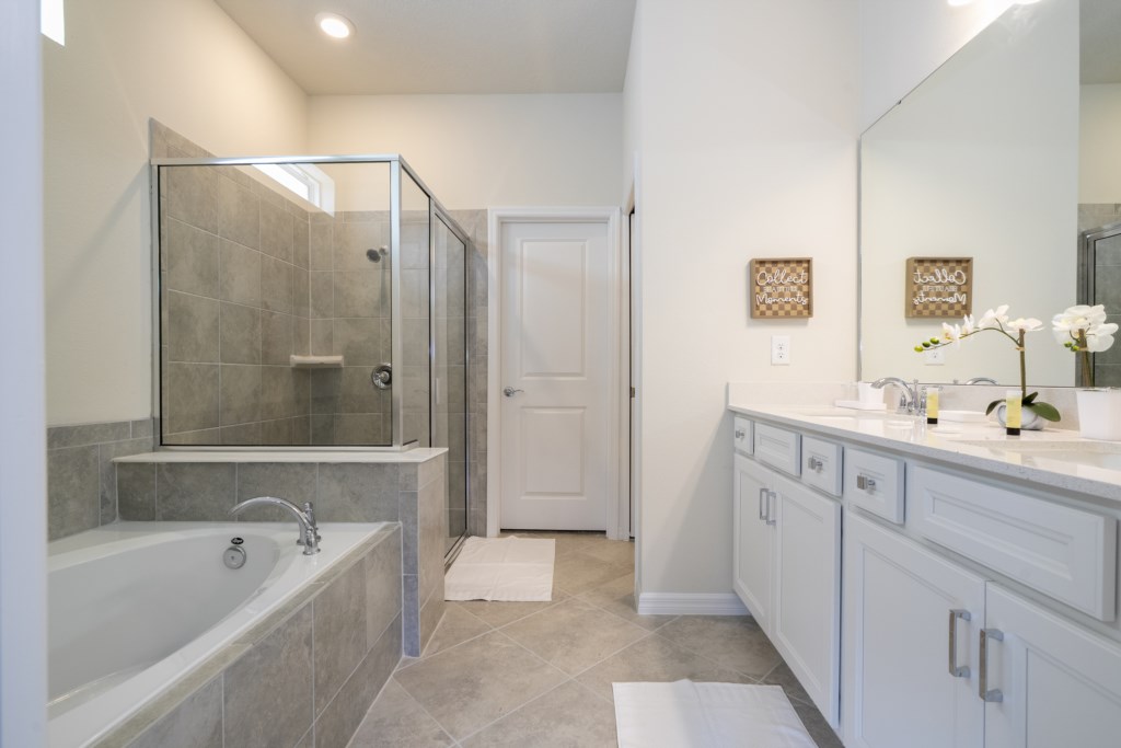King en-suite 1st floor bathroom w/ double sinks, walk in shower and garden tub