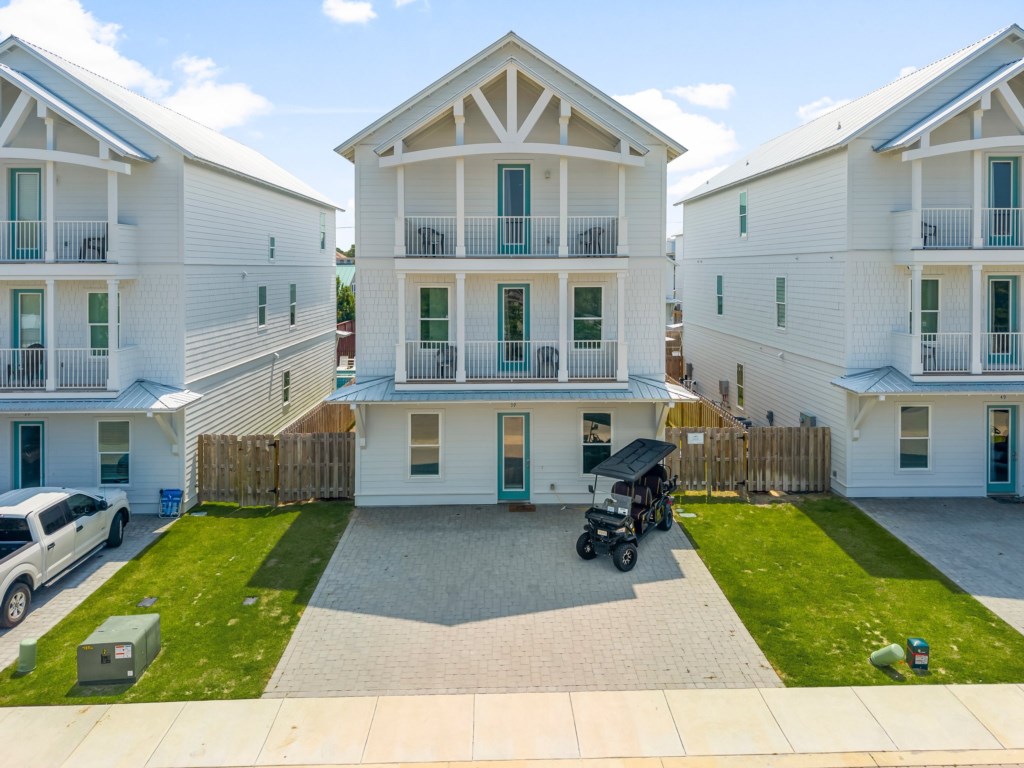 Aerial view of modern, spacious vacation homes with private parking.