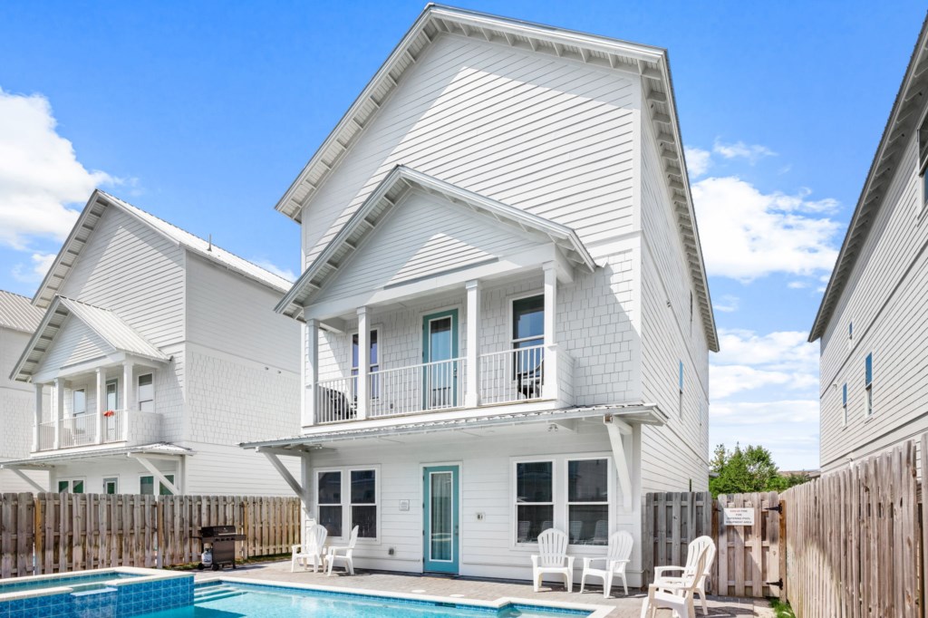 The spacious pool area has a spa and umbrella deck