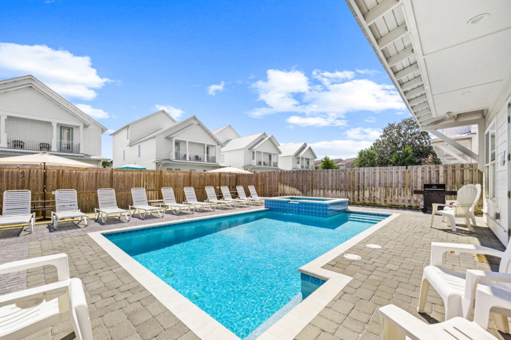 The spacious pool area has a spa and umbrella deck