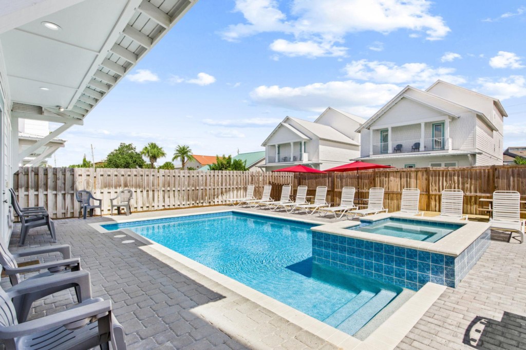 The spacious pool area has a spa and umbrella deck