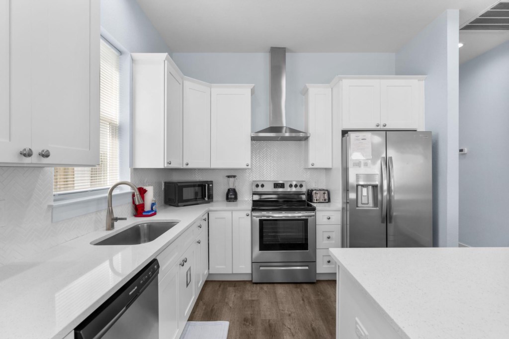 Modern kitchen with stainless steel appliances and ample counter space.