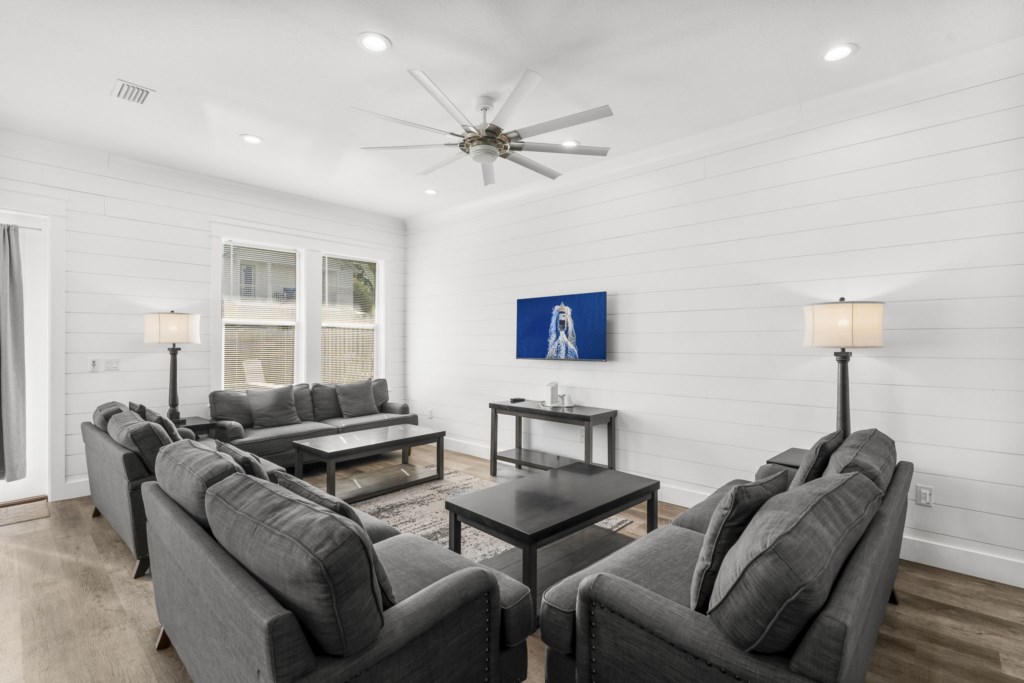Bright living room with plush sofas and modern decor, ideal for relaxing.