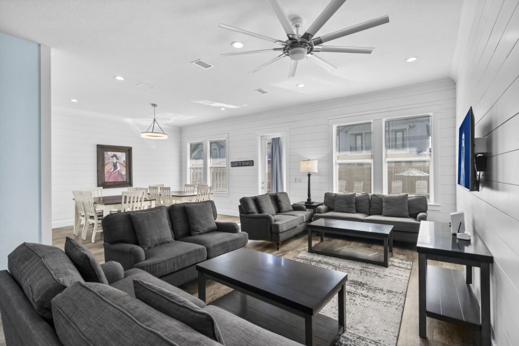 Spacious living room with plush sofas, modern decor, and ample natural light.