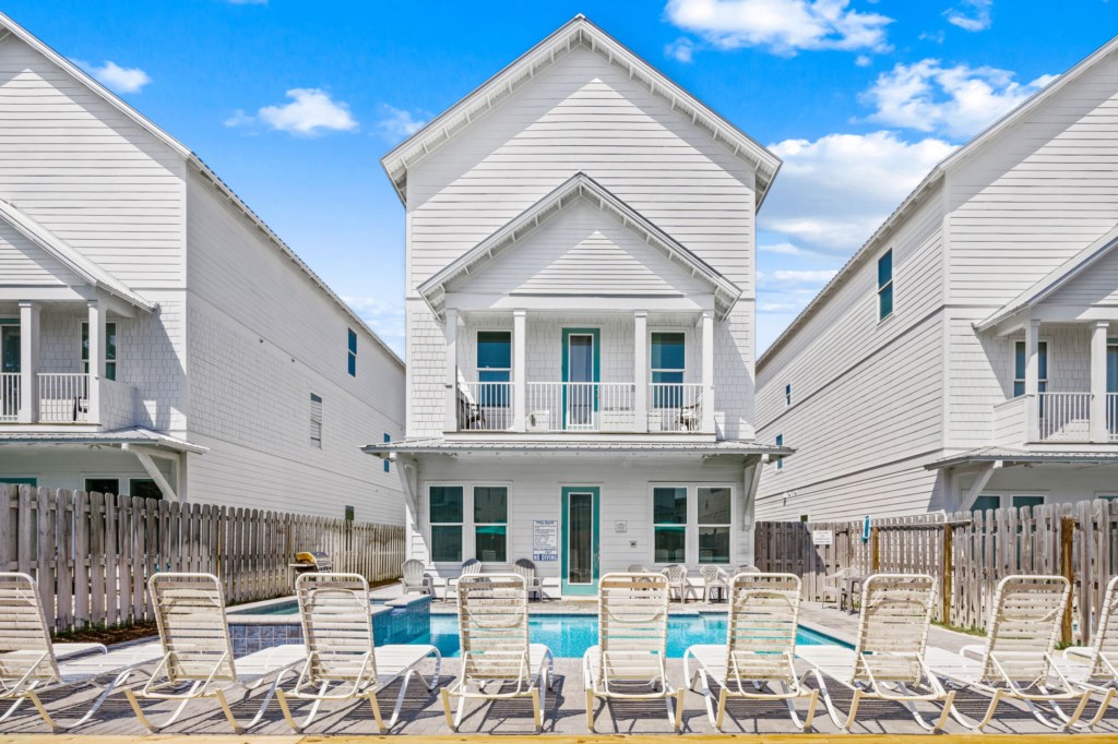 The spacious pool area has a spa and umbrella deck