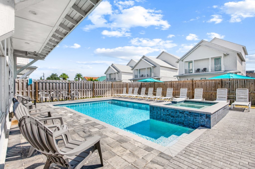 The spacious pool area has a spa and umbrella deck