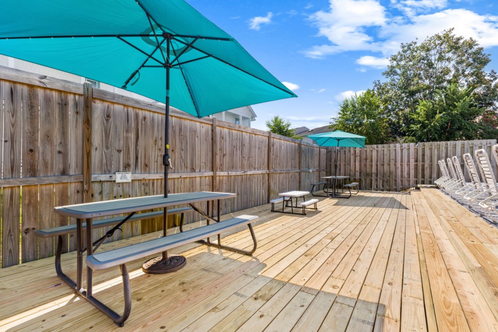 The spacious pool area has a spa and umbrella deck