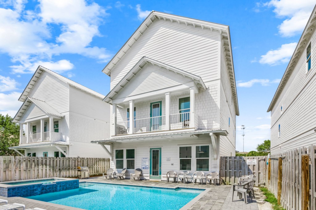The spacious pool area has a spa and umbrella deck