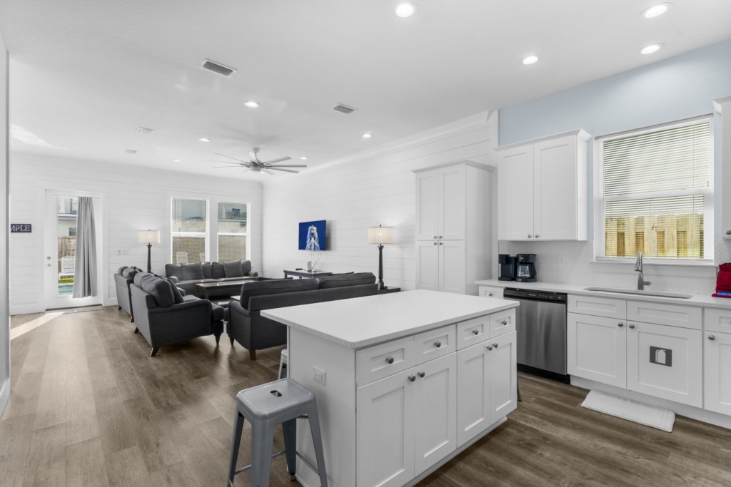 Spacious open-plan living area with modern kitchen and comfortable seating.