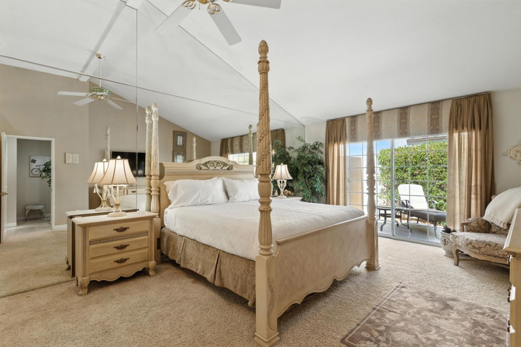 Elegant primary bedroom with direct patio access.
