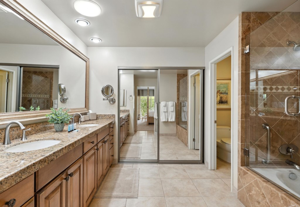 Spacious bathroom with dual vanities and a large shower and tub.
