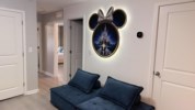Charming hallway seating area with a Disney-themed decor accent.