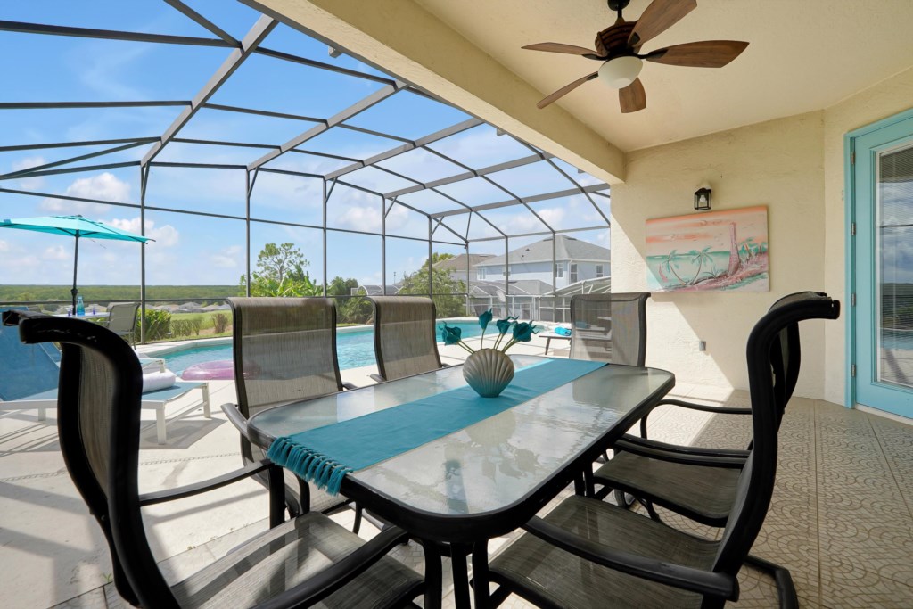 Outdoor dining area featuring a table that comfortably seats six, perfect for enjoying alfresco meals. 