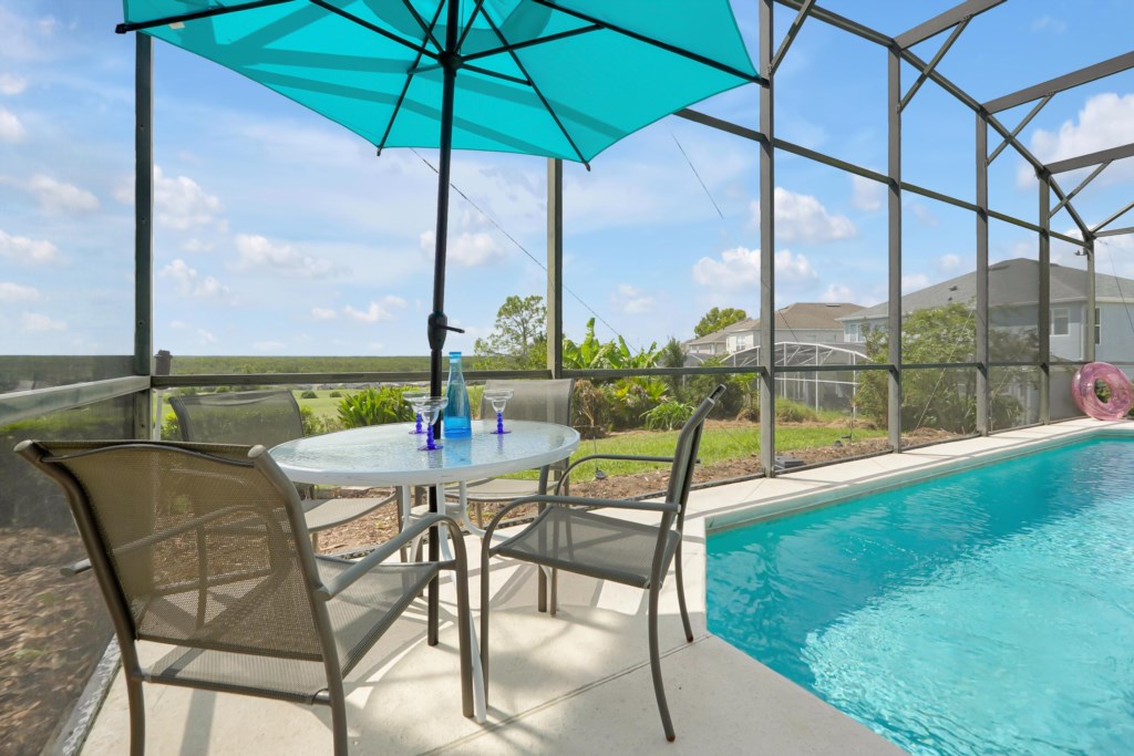 Outdoor space featuring comfortable seating for four, perfect for enjoying panoramic golf course views. 
