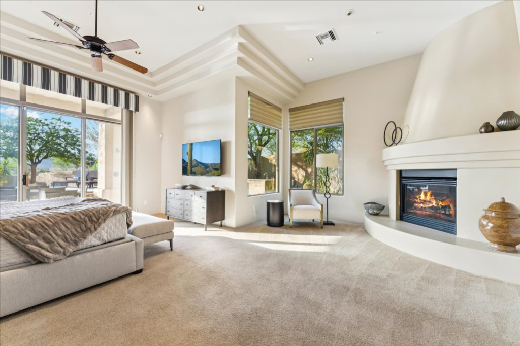 Elegant living area with a modern fireplace and sunlit garden views.
