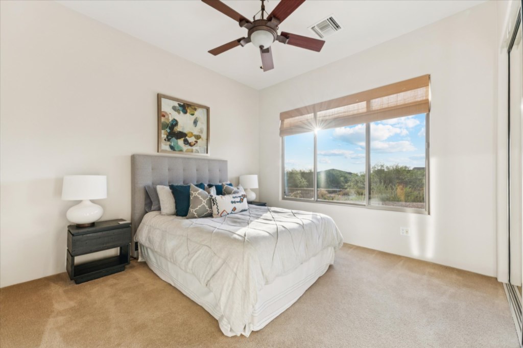 Serene bedroom with plush bedding and scenic mountain views.