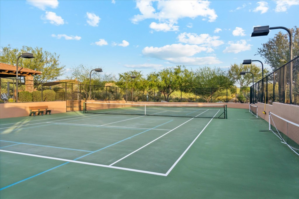 Private tennis court surrounded by natural scenery, perfect for an active getaway.