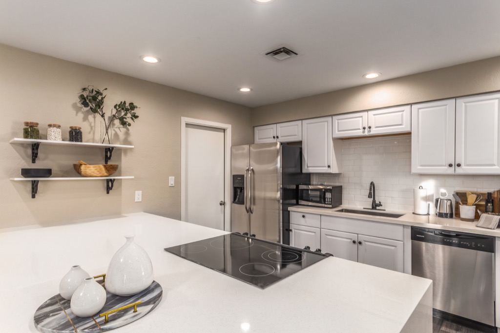 Modern kitchen with stainless steel appliances and sleek countertops.