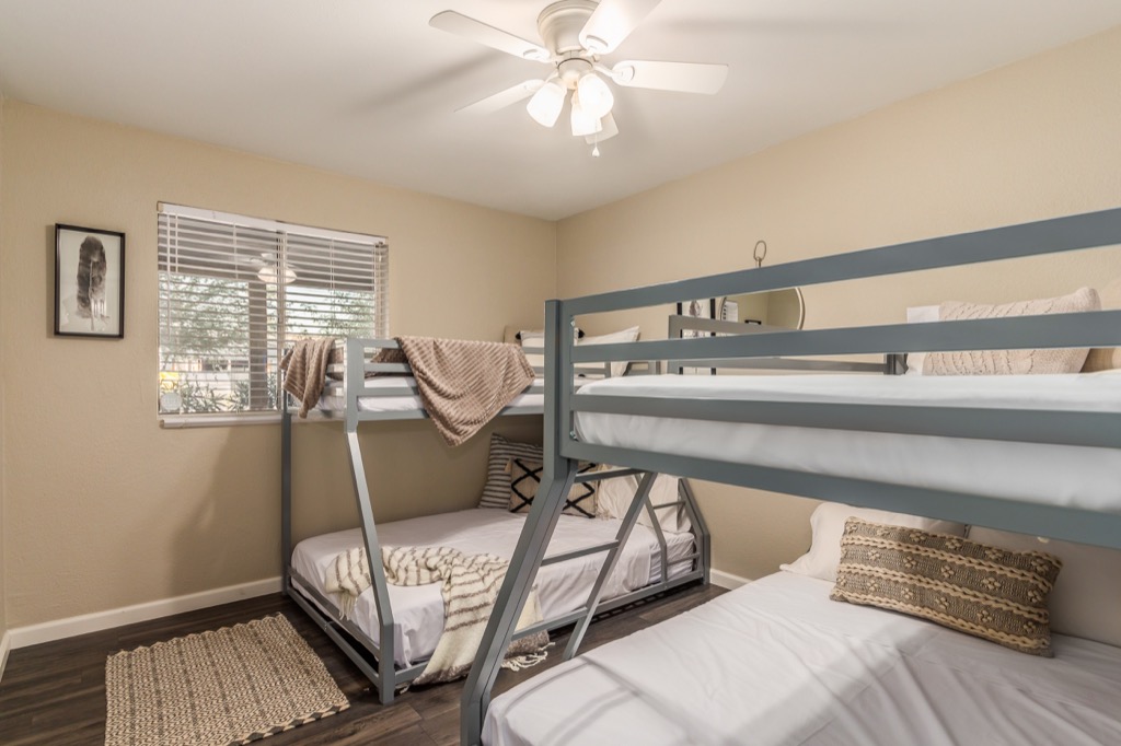 Comfortable guest room with a bunk bed and twin bed, ideal for family stays.
