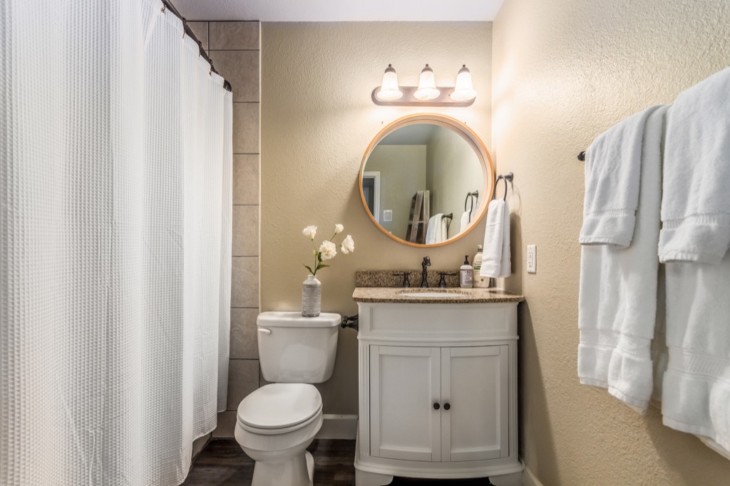Well-lit bathroom with elegant vanity and plush towels.