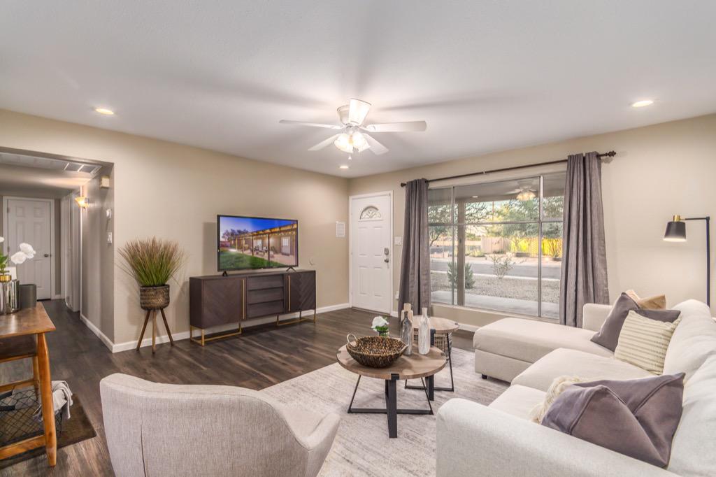 Spacious living room with modern decor and ample natural light.