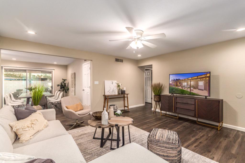 Spacious living room with modern furnishings and a large flat-screen TV.