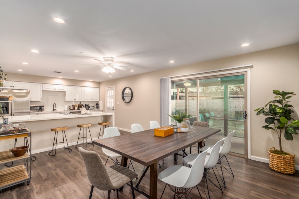 Modern open-plan dinning area, flows into a well-equipped kitchen.