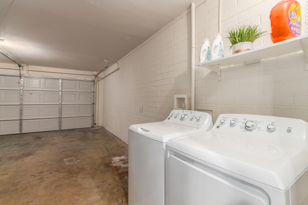 Clean garage with a dedicated laundry area, equipped with washer and dryer.