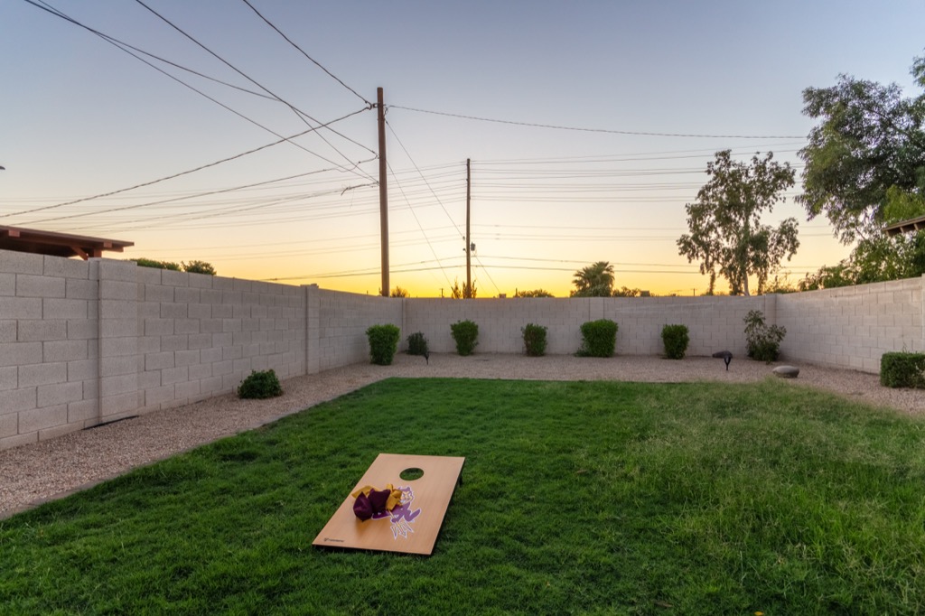 Spacious backyard with lush grass and a sunset view, ideal for relaxing evenings.
