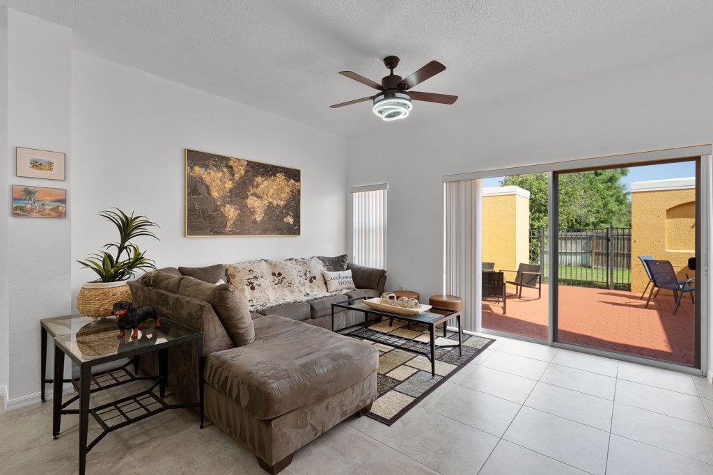Bright living area with dining set, cozy couch, and direct access to the patio.