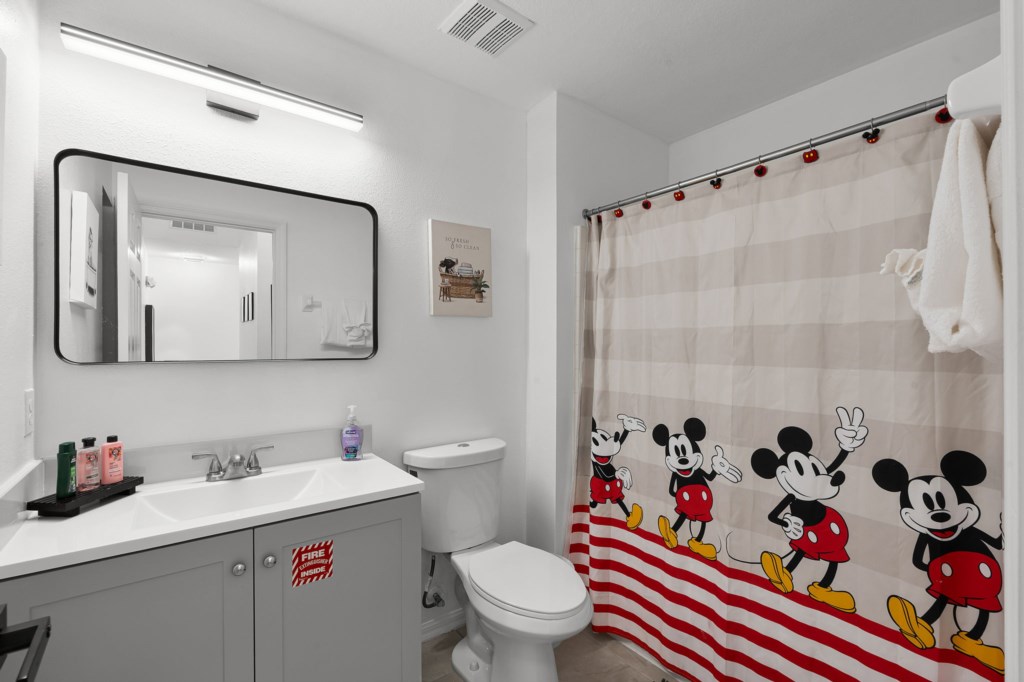 Spacious bath with vanity and soaking tub for ultimate relaxation.