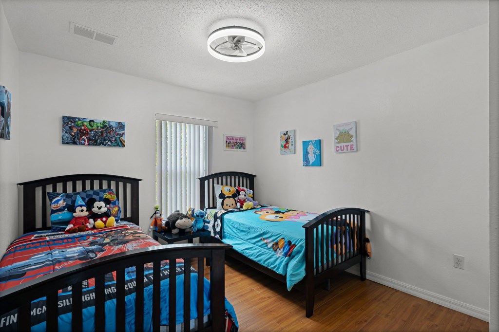 Fun kids’ room with twin beds and playful décor.