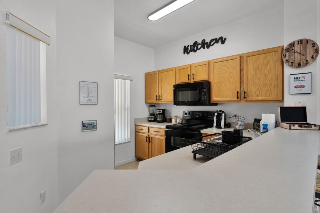 Sleek kitchen with breakfast bar and everything you need to cook at home.