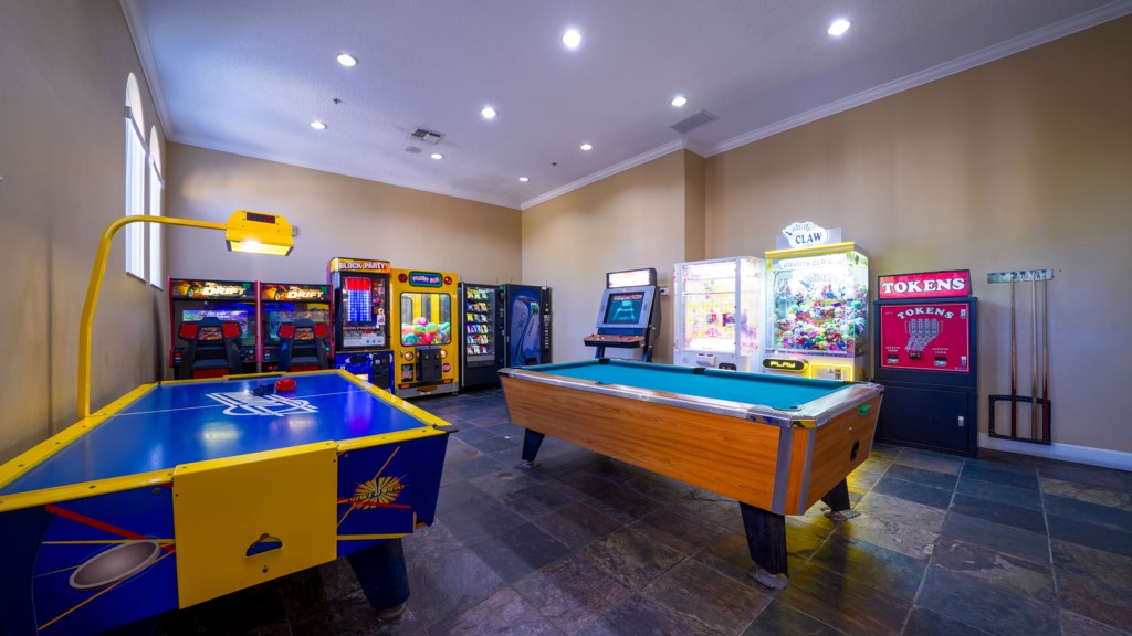 Fun-filled game room with pool table and classic arcade game for all ages.