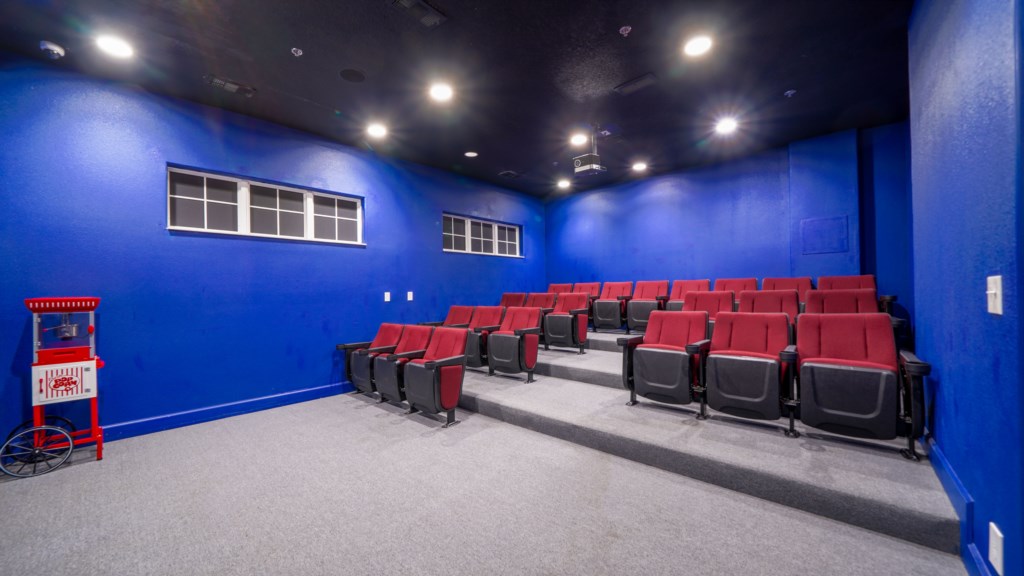 Cinema-style space with plush seating and large screen for the ultimate movie experience.