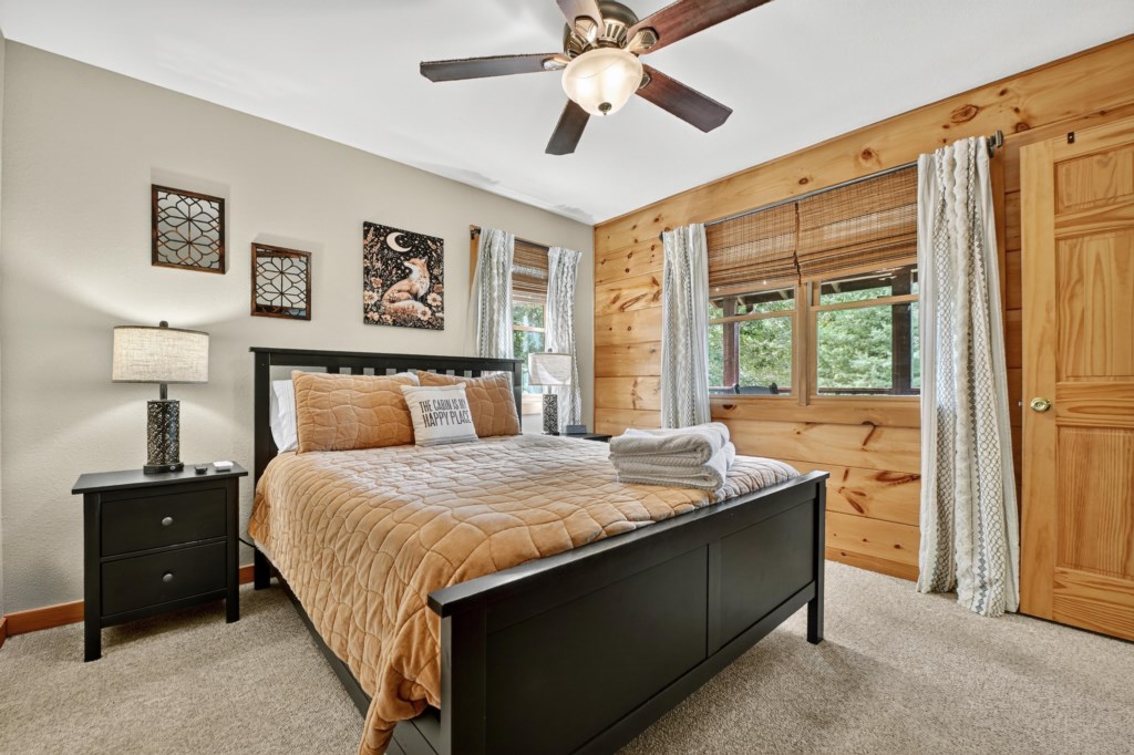 Rustic bedroom with a comfortable queen-sized bed and soothing natural light.