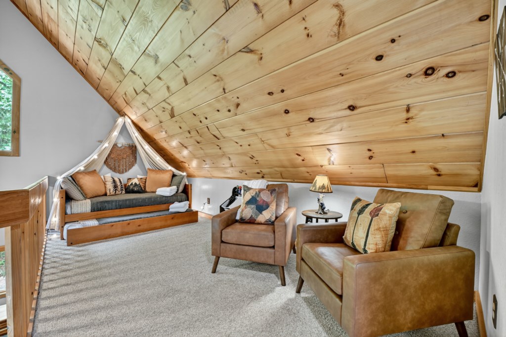 Cozy loft area with plush seating and window nook—perfect for reading.