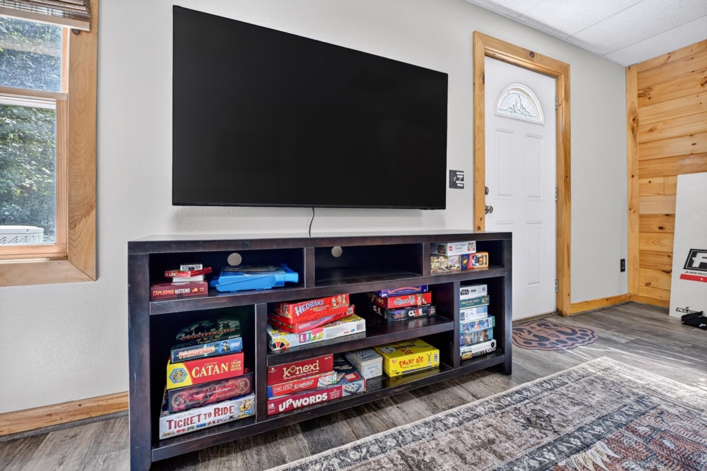 Game-filled entertainment area with large TV and popular board games.