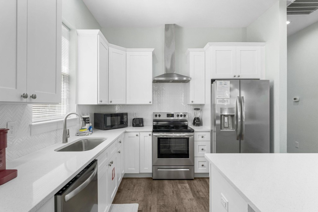 Spacious kitchen and open concept living area that leads to the pool