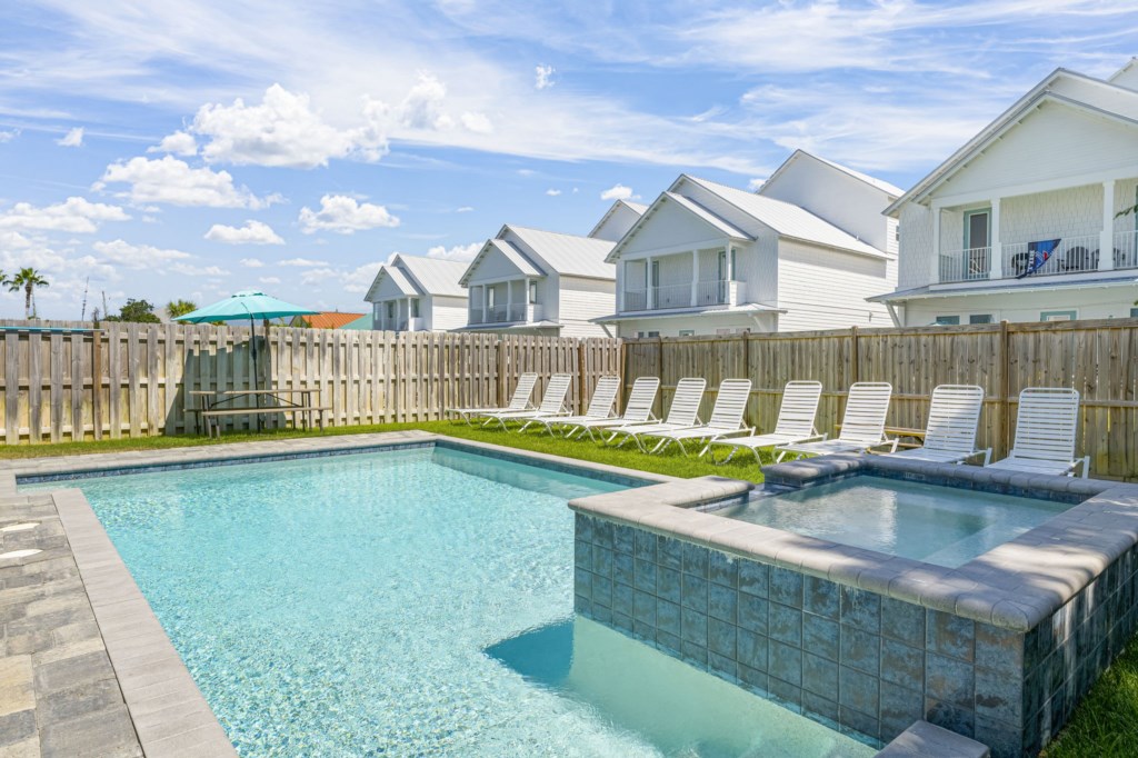 Pool area with a waterfall spa and gas grill