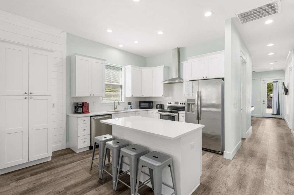 Spacious kitchen and open concept living area that leads to the pool