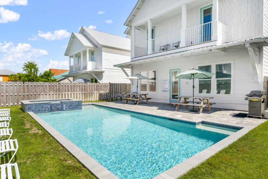 The spacious pool area at Ellis Sands has loungers and shade